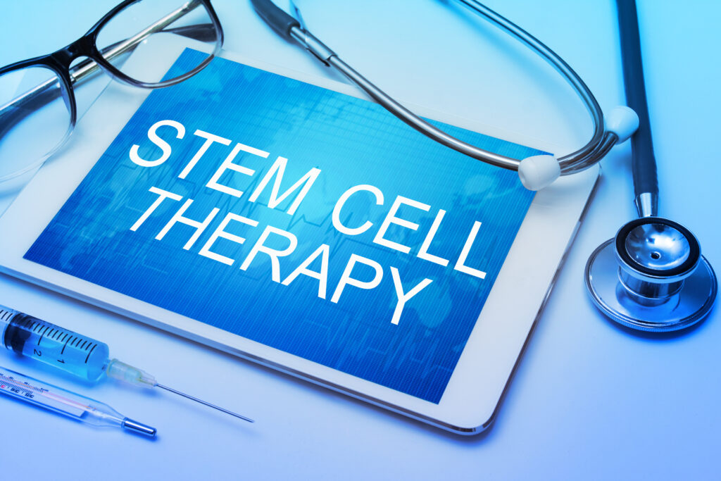 stem cell therapy word on tablet screen with medical equipment on background